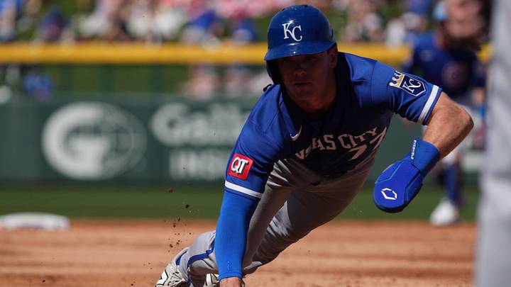 Mar 11, 2026; Mesa, Arizona, USA; Kansas City Royals second baseman Peyton Wilson (77) dives back to first against the Chicago Cubs in the third inning at Sloan Park. Mandatory Credit: Rick Scuteri-Imagn Images