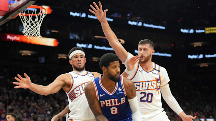Nov 4, 2024; Phoenix, Arizona, USA; Phoenix Suns guard Devin Booker (1) and Phoenix Suns center Jusuf Nurkic (20) guard Philadelphia 76ers forward Paul George (8) during the second half at Footprint Center. Mandatory Credit: Joe Camporeale-Imagn Images