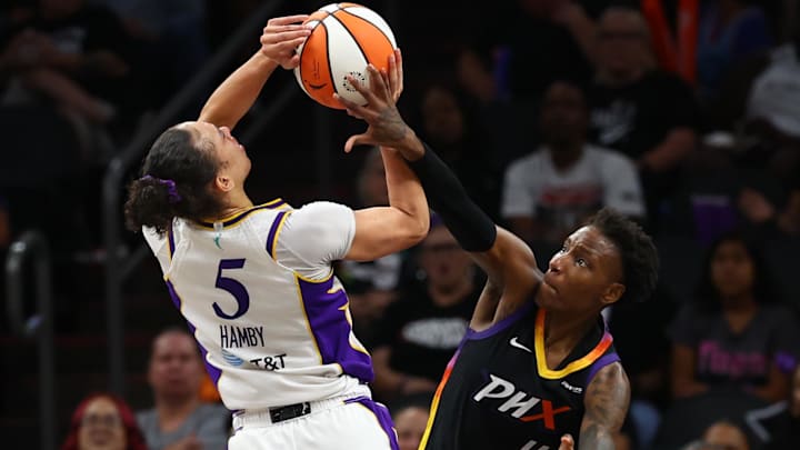 Sep 9, 2025; Phoenix, Arizona, USA; Los Angeles Sparks forward Dearica Hamby (5) is fouled by Phoenix Mercury forward Natasha Mack (4) during the second half of a WNBA game at PHX Arena. Mandatory Credit: Mark J. Rebilas-Imagn Images