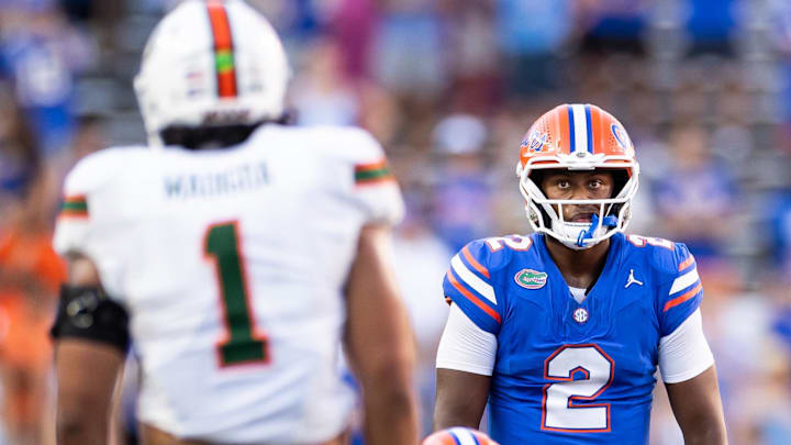 Aug 31, 2024; Gainesville, Florida, USA; Florida Gators quarterback DJ Lagway (2) stares at Miami Hurricanes linebacker Francisco Mauigoa (1) during the second half at Ben Hill Griffin Stadium. 