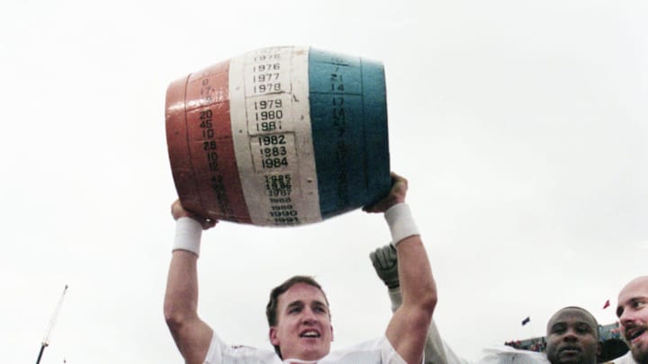 Tennessee quarterback Peyton Manning (16) lifts the beer barrel, which annually goes to the winner of the Vols-Kentucky SEC battle. The 5th-ranked Vols defeated the Wildcats 59-31 at Commonwealth Stadium in Lexington, Ky., Nov. 22, 1997.
