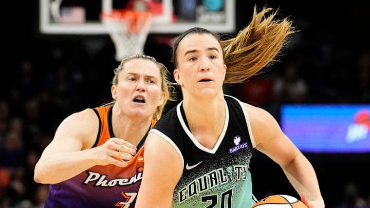 New York Liberty guard Sabrina Ionescu (20) controls the ball against Phoenix Mercury guard Sami Whitcomb (33) in overtime during Game One of the 2025 WNBA Playoffs first round at PHX Arena on Sept. 14, 2025.