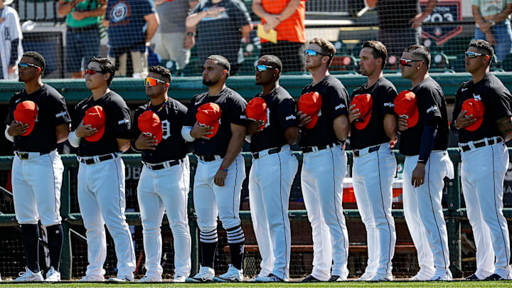 Tigers players look on during national anthem before the Grapefruit League season opener at Joker Marchant Stadium in Lakeland, Florida, on Saturday, Feb. 24, 2024.
