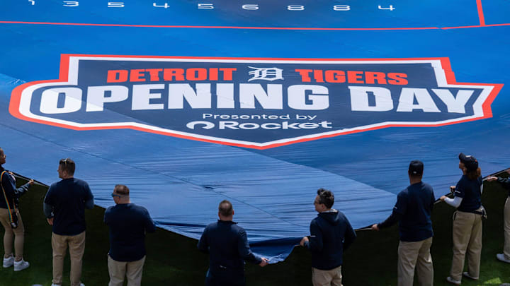 People hold a large Detroit Tigers Opening Day banner before the start of the game.