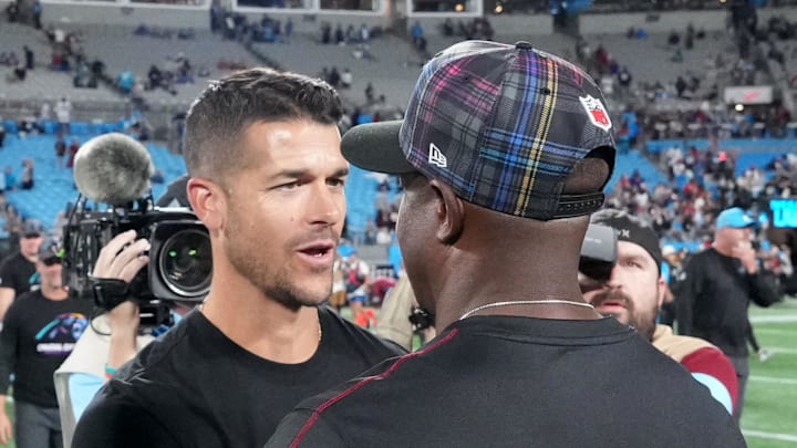 Carolina Panthers head coach Dave Canales talks with Atlanta Falcons head coach Raheem Morris.