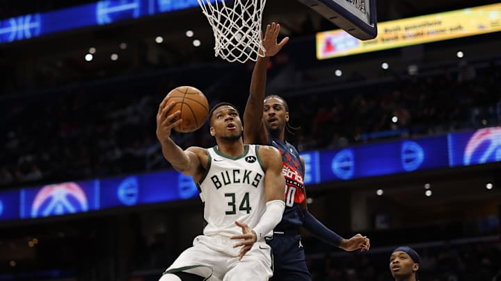 Feb 21, 2025; Washington, District of Columbia, USA; Milwaukee Bucks forward Giannis Antetokounmpo (34) shoots the ball as Washington Wizards forward Alex Sarr (20) defends in the first half at Capital One Arena. Mandatory Credit: Geoff Burke-Imagn Images