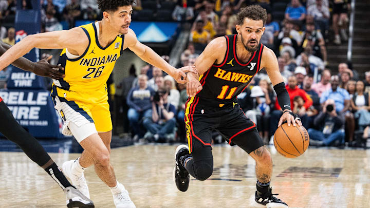 Trae Young dribbles the ball