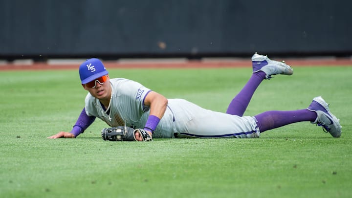 May 13, 2023; Stillwater, OK, USA; Kansas State Wildcats outfielder Cole Johnson (8) looks up after making a diving catch during the game against the Kansas State Wildcats at O'Brate Stadium. Mandatory Credit: Brett Rojo-Imagn Images May 13, 2023; Stillwater, OK, USA; Kansas State Wildcats outfielder Cole Johnson (8) looks up after making a diving catch during the game against the Kansas State Wildcats at O'Brate Stadium. Mandatory Credit: Brett Rojo-Imagn Images