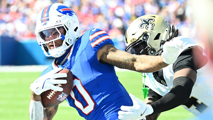 Buffalo Bills wide receiver Keon Coleman (0) runs for a gain past New Orleans Saints cornerback Kool-Aid McKinstry (4) during the first quarter at Highmark Stadium.