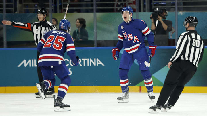 Feb 14, 2026; Milan, Italy;  Brady Tkachuk of United States celebrates scoring their second goal with Charlie McAvoy of United States against Denmark in men's ice hockey group C play during the Milano Cortina 2026 Olympic Winter Games at Milano Santagiulia Ice Hockey Arena. Mandatory Credit: Geoff Burke-Imagn Images