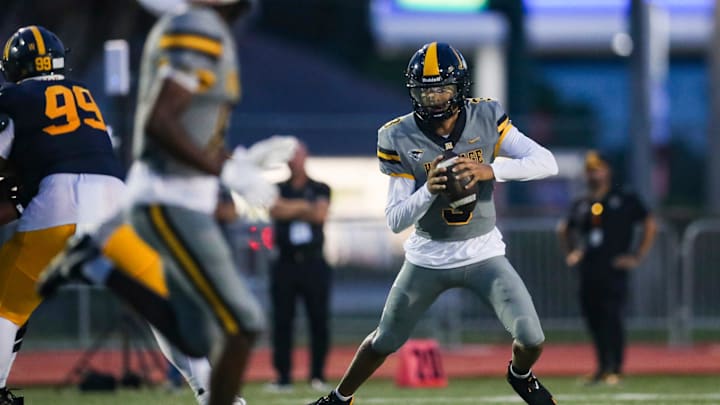 American Heritage Patriots quarterback Dia Bell (3) scrambles in the backfield during the first quarter of a game against the Naples Golden Eagles at Staver Field in Naples on Friday, Sept. 13, 2024.