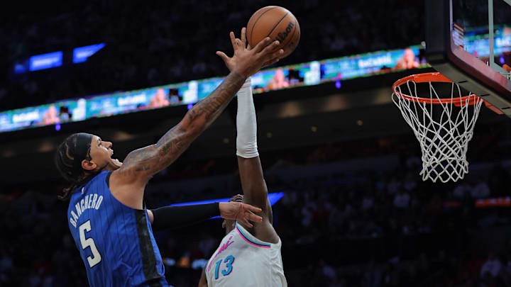 Orlando Magic forward Paolo Banchero (5) drives to the basket against Miami Heat center Bam Adebayo (13) during the fourth quarter at Kaseya Center.