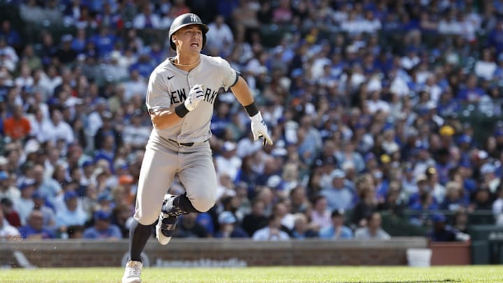 Sep 6, 2024; Chicago, Illinois, USA; New York Yankees shortstop Anthony Volpe (11) runs after hitting a single against the Chicago Cubs during the ninth inning at Wrigley Field.