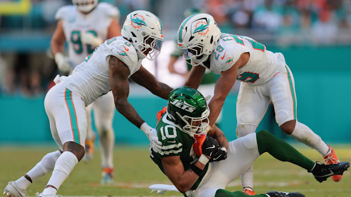 Dec 8, 2024; Miami Gardens, Florida, USA; New York Jets wide receiver Allen Lazard (10) is stopped by Miami Dolphins safety Jevon Holland (8) and cornerback Kendall Fuller (29) during the fourth quarter at Hard Rock Stadium. Mandatory Credit: Sam Navarro-Imagn Images Dec 8, 2024; Miami Gardens, Florida, USA; New York Jets wide receiver Allen Lazard (10) is stopped by Miami Dolphins safety Jevon Holland (8) and cornerback Kendall Fuller (29) during the fourth quarter at Hard Rock Stadium. Mandatory Credit: Sam Navarro-Imagn Images