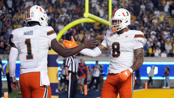 Miami Hurricanes quarterback Cam Ward (1) is congratulated by tight end Elijah Arroyo (8) after scoring a touchdown against the California Golden Bears during the fourth quarter at California Memorial Stadium. 