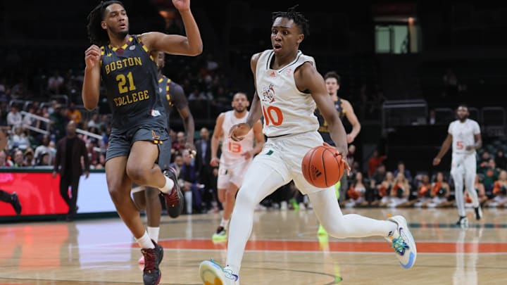 Mar 6, 2024; Coral Gables, Florida, USA; Miami Hurricanes guard Paul Djobet (10) drives to the basket against Boston College Eagles forward Devin McGlockton (21) during the second half at Watsco Center. Mandatory Credit: Sam Navarro-Imagn Images Mar 6, 2024; Coral Gables, Florida, USA; Miami Hurricanes guard Paul Djobet (10) drives to the basket against Boston College Eagles forward Devin McGlockton (21) during the second half at Watsco Center. Mandatory Credit: Sam Navarro-Imagn Images