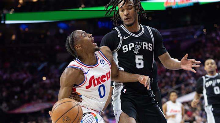 Dec 23, 2024; Philadelphia, Pennsylvania, USA; Philadelphia 76ers guard Tyrese Maxey (0) drives against San Antonio Spurs guard Stephon Castle (5) during the second quarter at Wells Fargo Center. Mandatory Credit: Bill Streicher-Imagn Images