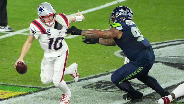 New England Patriots quarterback Drake Maye (10) is pressured by Seattle Seahawks defensive tackle Byron Murphy II (91) in the second half in Super Bowl LX at Levi's Stadium.