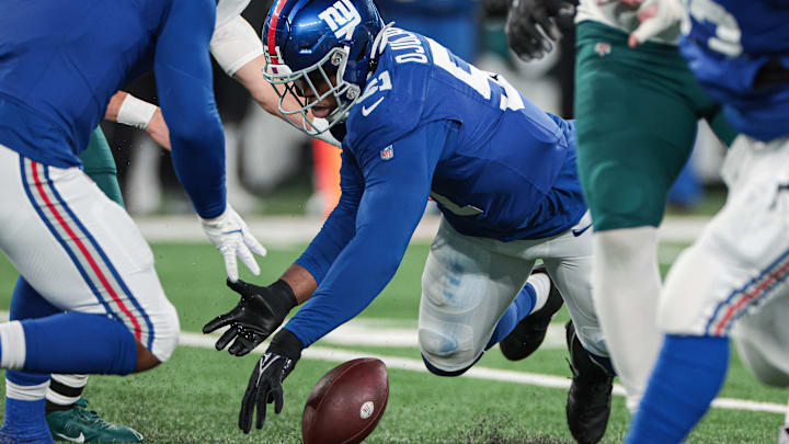 Jan 7, 2024; East Rutherford, New Jersey, USA; New York Giants linebacker Azeez Ojulari (51) recovers a fumble by Philadelphia Eagles quarterback Marcus Mariota (not pictured) during the second half at MetLife Stadium. Mandatory Credit: Vincent Carchietta-Imagn Images Jan 7, 2024; East Rutherford, New Jersey, USA; New York Giants linebacker Azeez Ojulari (51) recovers a fumble by Philadelphia Eagles quarterback Marcus Mariota (not pictured) during the second half at MetLife Stadium. Mandatory Credit: Vincent Carchietta-Imagn Images