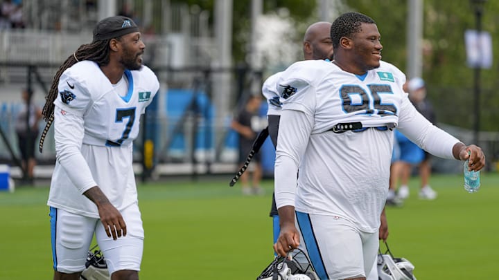 Jul 30, 2024; Charlotte, NC, USA; Carolina Panthers Derrick Brown (95) and linebacker Jadeveon Clowney (7) at Carolina Panthers Practice Fields. Mandatory Credit: Jim Dedmon-Imagn Images
