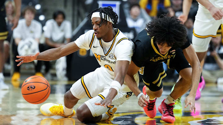 Feb 18, 2026; Columbia, Missouri, USA; Missouri Tigers guard Anthony Robinson II (0) and Vanderbilt Commodores guard Tyler Tanner (3) fight for a loose ball during the second half of the game at Mizzou Arena. Mandatory Credit: Denny Medley-Imagn Images