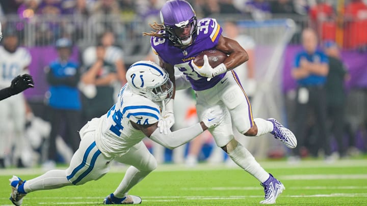 Nov 3, 2024; Minneapolis, Minnesota, USA; Minnesota Vikings running back Aaron Jones (33) runs with the ball against the Indianapolis Colts linebacker Zaire Franklin (44) in the first quarter at U.S. Bank Stadium. Mandatory Credit: Brad Rempel-Imagn Images