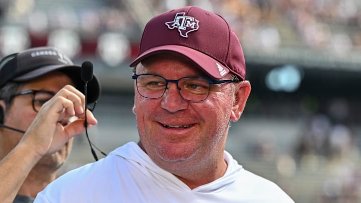 Oct 5, 2024; College Station, Texas, USA; Texas A&M Aggies head coach Mike Elko gets ready for a pre-game interview with the SEC Nation prior to the game against the Missouri Tigers at Kyle Field. Mandatory Credit: Maria Lysaker-Imagn Images. 
