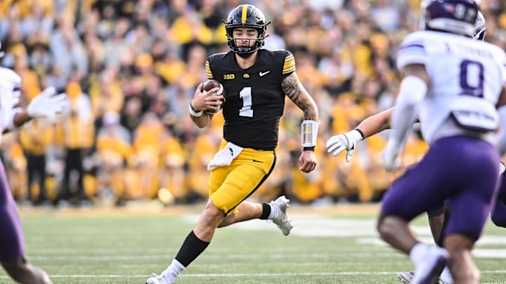 Oct 26, 2024; Iowa City, Iowa, USA; Iowa Hawkeyes quarterback Brendan Sullivan (1) runs for yardage against the Northwestern Wildcats during the second quarter at Kinnick Stadium. Mandatory Credit: Jeffrey Becker-Imagn Images