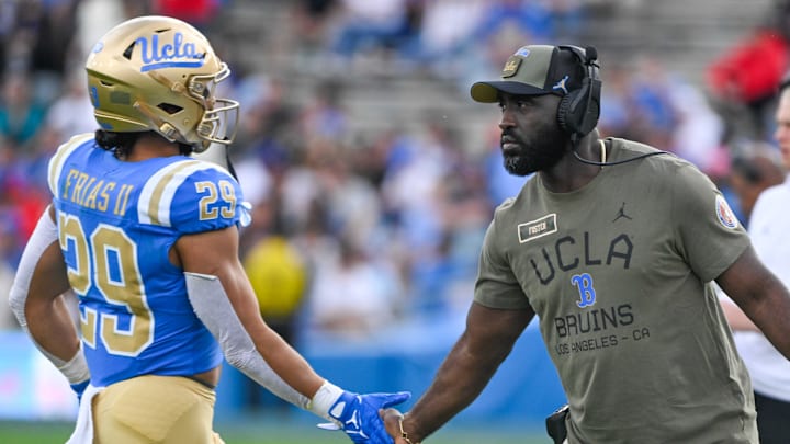 Nov 30, 2024; Pasadena, California, USA; UCLA Bruins head coach DeShaun Foster greets UCLA Bruins running back Anthony Frias II (29) as he returns to the bench during the third quarter against the Fresno State Bulldogs at Rose Bowl. Mandatory Credit: Robert Hanashiro-Imagn Images