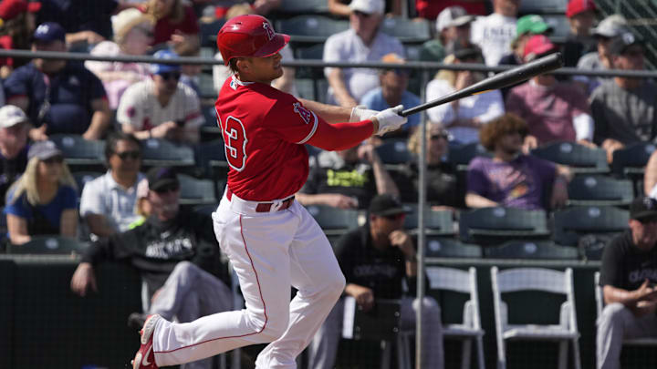 Mar 8, 2023; Tempe, Arizona, USA; Los Angeles Angels catcher Max Stassi (33) hits a single against the Colorado Rockies in the fourth inning at Tempe Diablo Stadium. 