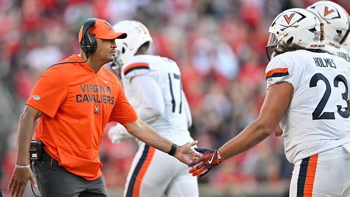 Oct 4, 2025; Louisville, Kentucky, USA; Virginia Cavaliers head coach Tony Elliott celebrates with defensive lineman Jacob Holmes (23) during the second half against the Louisville Cardinals at L&N Federal Credit Union Stadium. Virginia defeated Louisville 30-27. Mandatory Credit: Jamie Rhodes-Imagn Images Oct 4, 2025; Louisville, Kentucky, USA; Virginia Cavaliers head coach Tony Elliott celebrates with defensive lineman Jacob Holmes (23) during the second half against the Louisville Cardinals at L&N Federal Credit Union Stadium. Virginia defeated Louisville 30-27. Mandatory Credit: Jamie Rhodes-Imagn Images