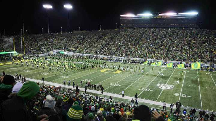 Nov 24, 2023; Eugene, Oregon, USA; Oregon Ducks fans cheer as the Ducks football team take the field before a game against the Oregon State Beavers at Autzen Stadium.