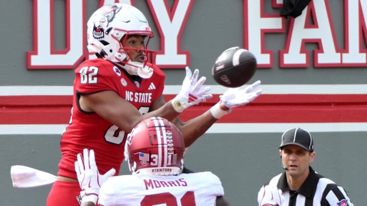 Nov 2, 2024; Raleigh, North Carolina, USA; North Carolina State Wolfpack wide receiver Keenan Jackson (82) catches the ball under pressure from Stanford Cardinals cornerback Aaron Morris (31) during the second quarter for a touchdown against Stanford Cardinals at Carter-Finley Stadium. Mandatory Credit: Zachary Taft-Imagn Images Nov 2, 2024; Raleigh, North Carolina, USA; North Carolina State Wolfpack wide receiver Keenan Jackson (82) catches the ball under pressure from Stanford Cardinals cornerback Aaron Morris (31) during the second quarter for a touchdown against Stanford Cardinals at Carter-Finley Stadium. Mandatory Credit: Zachary Taft-Imagn Images