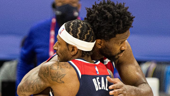 Dec 23, 2020; Philadelphia, Pennsylvania, USA; Philadelphia 76ers center Joel Embiid (21) and Washington Wizards guard Bradley Beal (3) hug at center court after a 76ers victory at Wells Fargo Center. Mandatory Credit: Bill Streicher-Imagn Images