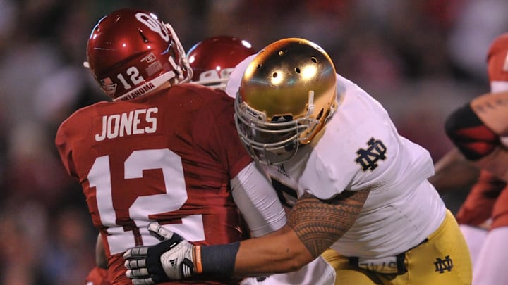 Oct. 27, 2012; Norman, OK, USA; Notre Dame Fighting Irish linebacker Manti Te'o (5) sacks Oklahoma Sooners quarterback Landry Jones (12) in the second quarter at Oklahoma Memorial Stadium. Notre Dame won 30-13. 