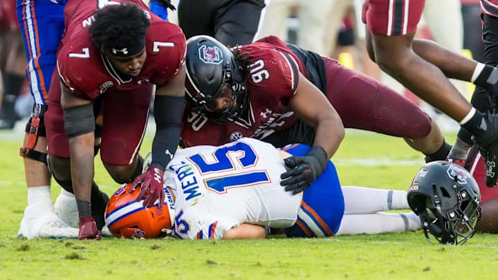 Oct 14, 2023; Columbia, South Carolina, USA; South Carolina Gamecocks defensive end Jordan Strachan (7) and South Carolina Gamecocks defensive tackle T.J. Sanders (90) get up after sacking Florida Gators quarterback Graham Mertz (15)
