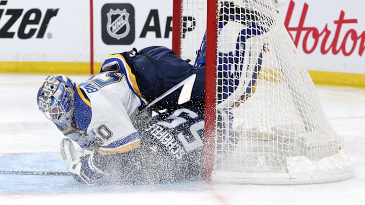 Apr 21, 2025; Winnipeg, Manitoba, CAN;Winnipeg Jets center Mark Scheifele (55) slides into St. Louis Blues goaltender Jordan Binnington (50) in the second period in game two of the first round of the 2025 Stanley Cup Playoffs at Canada Life Centre. Mandatory Credit: James Carey Lauder-Imagn Images
