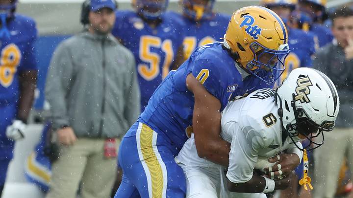 Sep 12, 2026; Pittsburgh, Pennsylvania, USA;  UCF Knights wide receiver Ric'darious Farmer (6) makes a catch  as Pittsburgh Panthers linebacker Braylan Lovelace (0) tackles during the first quarter  at Acrisure Stadium.  Mandatory Credit: Charles LeClaire-Imagn Images