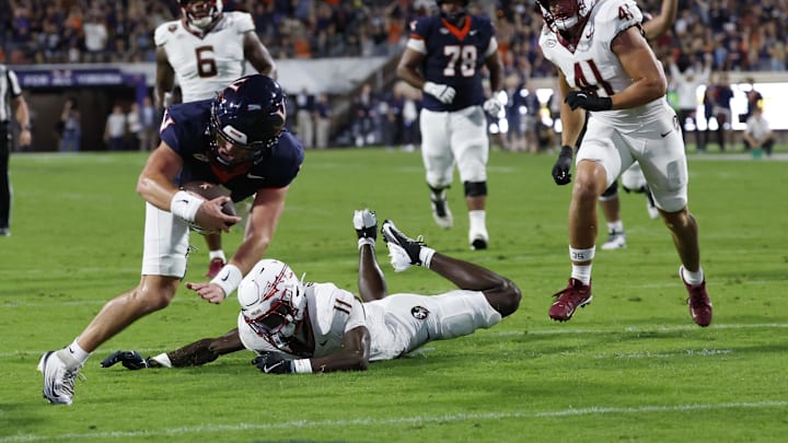 Sep 26, 2025; Charlottesville, Virginia, USA; Virginia Cavaliers quarterback Chandler Morris (4) scores a touchdown s Florida State Seminoles defensive back Ja'Bril Rawls (11) defends during the second quarter at Scott Stadium. Mandatory Credit: Geoff Burke-Imagn Images