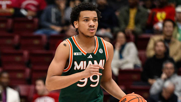 Jan 22, 2025; Stanford, California, USA; Miami (FL) Hurricanes guard Divine Ugochukwu (99) dribbles against the Stanford Cardinal in the first half at Maples Pavilion. Mandatory Credit: Eakin Howard-Imagn Images