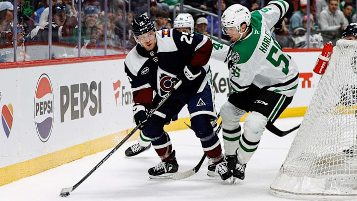 Mar 16, 2025; Denver, Colorado, USA; Colorado Avalanche right wing Logan O'Connor (25) controls the puck as Dallas Stars defenseman Thomas Harley (55) defends in the second period at Ball Arena. Mandatory Credit: Isaiah J. Downing-Imagn Images