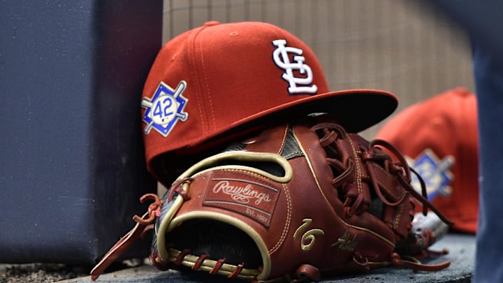 Apr 15, 2019; Milwaukee, WI, USA; A cap rests on the dug out wall with the number 42 on the hat in honor of Major League Baseball   s Jackie Robinson Day. Mandatory Credit: Michael McLoone-Imagn Images