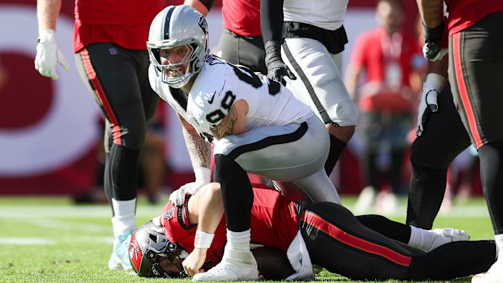 Dec 8, 2024; Tampa, Florida, USA; Las Vegas Raiders defensive end Maxx Crosby (98) sacks Tampa Bay Buccaneers quarterback Baker Mayfield (6) in the second quarter at Raymond James Stadium. Mandatory Credit: Nathan Ray Seebeck-Imagn Images
