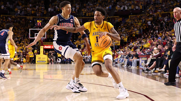 Arizona State's BJ Freeman (right) drives to the basket against Arizona's Carter Bryant during the Sun Devils' 82-71 loss to the rival Wildcats on Saturday, Feb. 1, 2025.