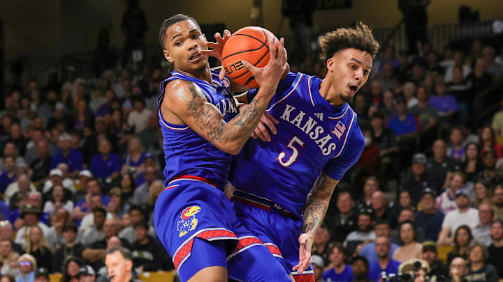 Jan 5, 2025; Orlando, Florida, USA; Kansas Jayhawks guard Shakeel Moore (0) and guard Zeke Mayo (5) jump for the rebound during the first half at Addition Financial Arena. Mandatory Credit: Mike Watters-Imagn Images