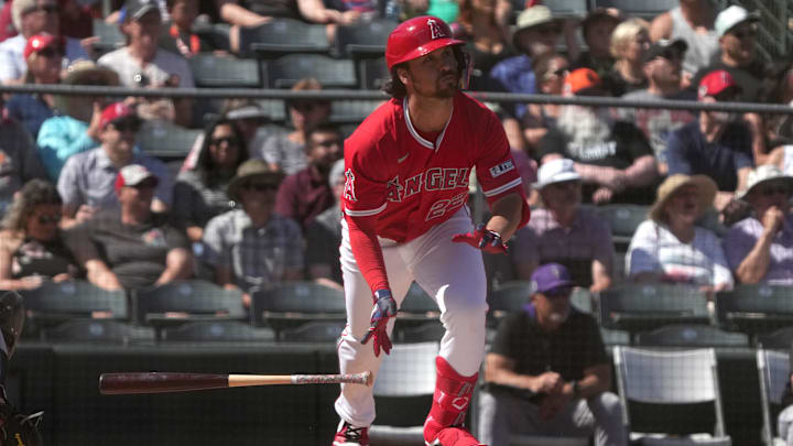 Mar 10, 2025; Tempe, Arizona, USA; Los Angeles Angels JD Davis hits a double against the Colorado Rockies in the second inning at Tempe Diablo Stadium. Mandatory Credit: Rick Scuteri-Imagn Images