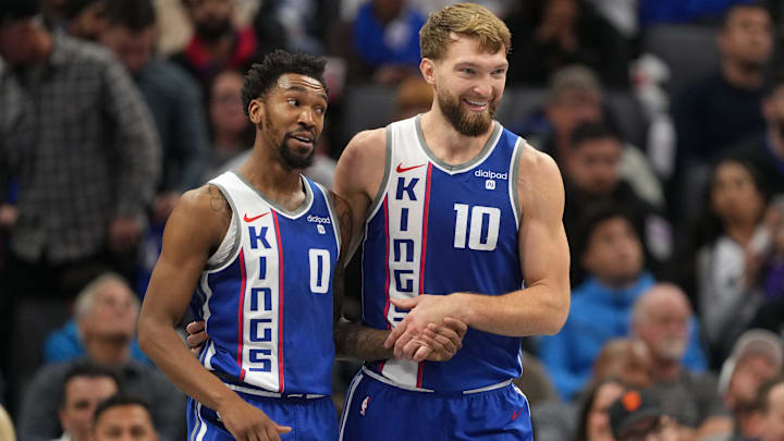 Sacramento Kings guard Malik Monk (0) talks with forward Domantas Sabonis. 
