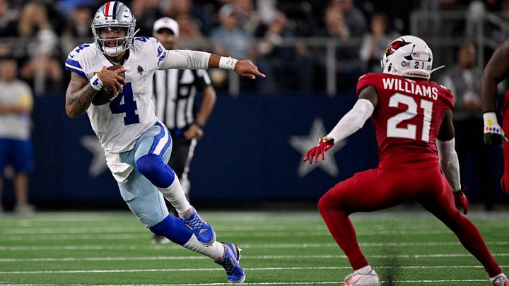Dallas Cowboys quarterback Dak Prescott (4) runs with the ball past Arizona Cardinals cornerback Garrett Williams (21) during the game between the Dallas Cowboys and the Arizona Cardinals at AT&T Stadium. Mandatory Credit: Jerome Miron-Imagn Images