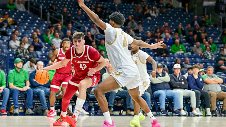 Mar 5, 2025; South Bend, Indiana, USA; Stanford Cardinal forward Maxime Raynaud (42) drives to the basket as Notre Dame Fighting Irish guard Sir Mohammed (4) defends in the second half at the Purcell Pavilion. Mandatory Credit: Matt Cashore-Imagn Images