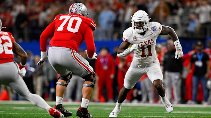 Jan 10, 2025; Arlington, TX, USA; Ohio State Buckeyes offensive lineman Josh Fryar (70) and Texas Longhorns linebacker Colin Simmons (11) in action during the game between the Texas Longhorns and the Ohio State Buckeyes at AT&T Stadium. Mandatory Credit: Jerome Miron-Imagn Images